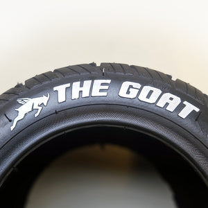 Image illustrates a close up of the lettering on the goat tire, sold exclusively from Flight Fins. The tire is in black and includes vector image of a goat and the text the goat - all in white - set in front of a white background.